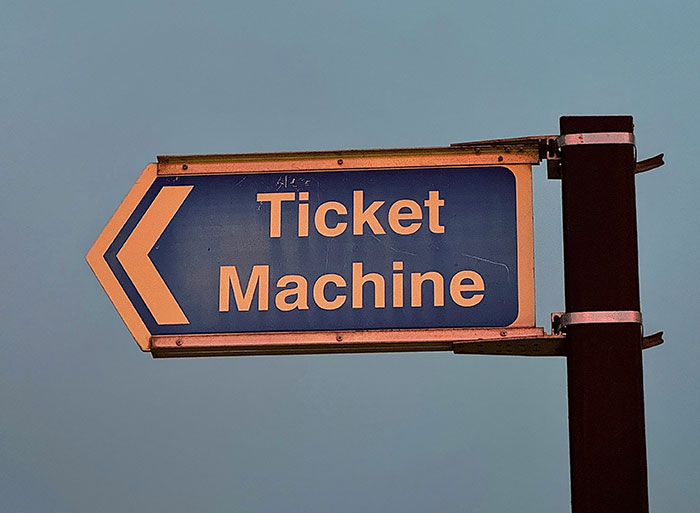 Directional sign for ticket machine at a zoo entrance, relevant for people who have worked in a zoo.