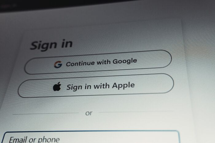Sign in screen showing options to continue with Google or sign in with Apple on a login page related to trust issues.