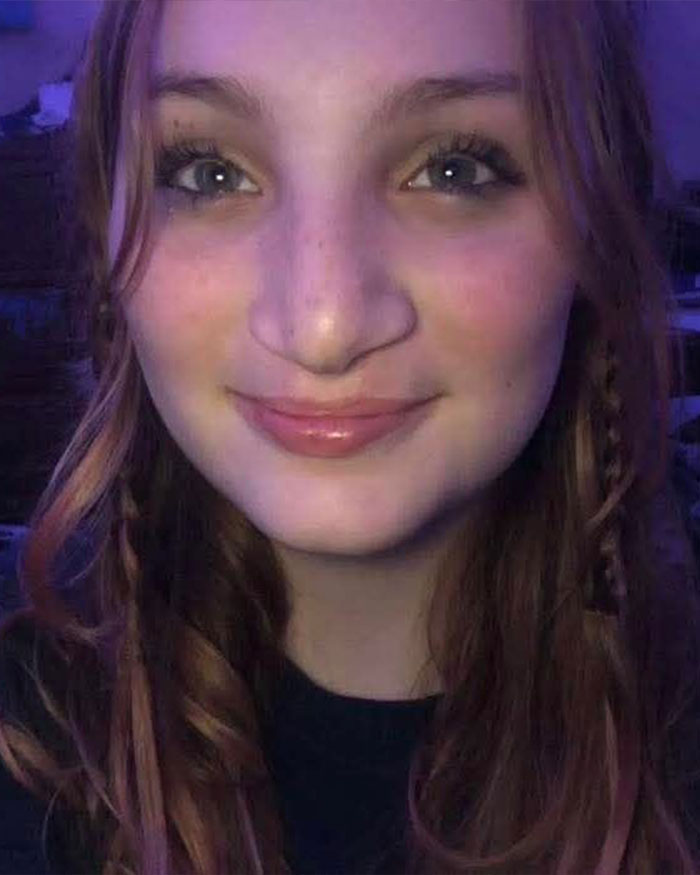 Close-up of a smiling teenage girl with long hair, related to two teens charged with homicide after brutal attack. Close-up of a smiling teenage girl with long hair, related to two teens charged with homicide after brutal attack.