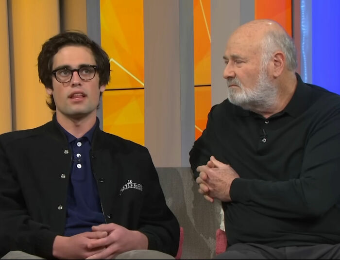 Two men in a studio discussing the horrific state of Nick Reiner's hotel room amid arrest for Father Rob's slaying.