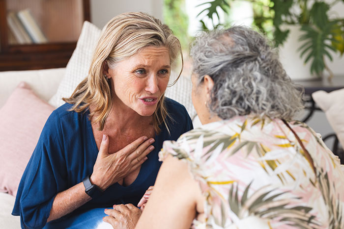 Middle-aged woman upset, confronting older woman about family issues after premature birth in a home setting. Middle-aged woman upset, confronting older woman about family issues after premature birth in a home setting.