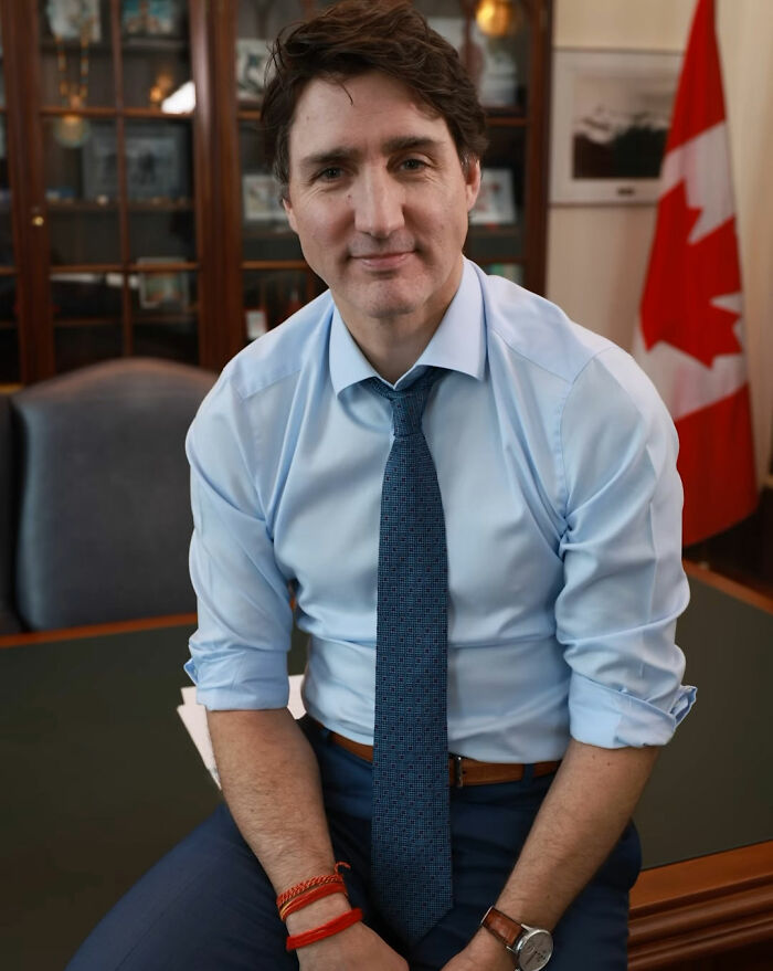 Justin Trudeau sitting casually in an office with Canadian flag, representing a meeting with Japan's Ex-PM and Katy Perry. Justin Trudeau sitting casually in an office with Canadian flag, representing a meeting with Japan's Ex-PM and Katy Perry.