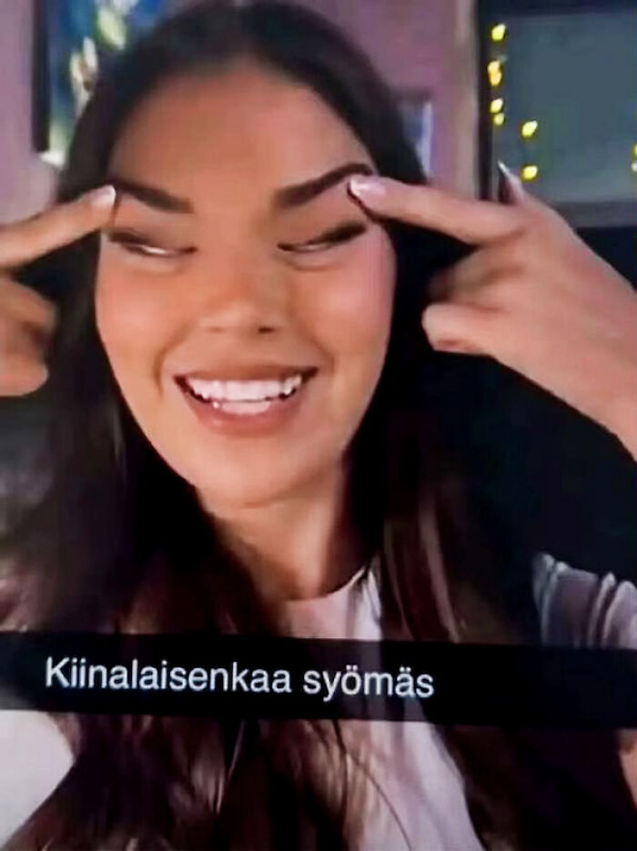Young woman smiling and making a controversial gesture, linked to Miss Finland losing crown after racist backlash on social media.