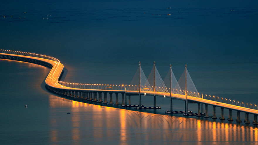 Long illuminated bridge at night showcasing remarkable engineering of one of the longest bridges in the world.
