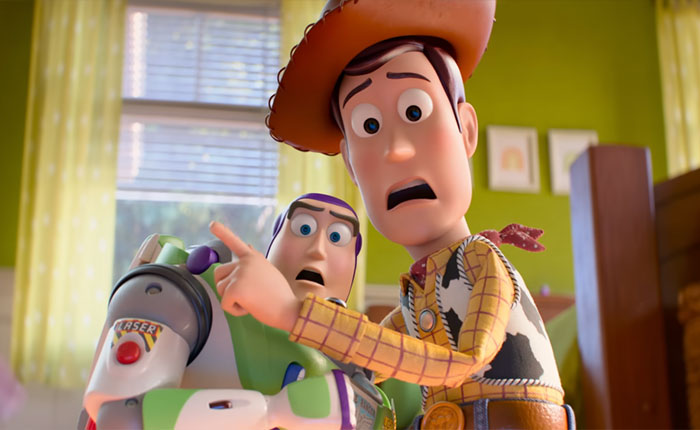 Woody and Buzz Lightyear reacting with shock in a bright room, fans discussing Andy's mom from Toy Story.