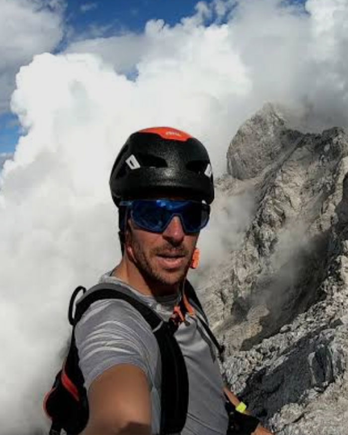 Man wearing helmet and sunglasses taking a selfie on a rocky Austrian mountain linked to boyfriend who abandoned woman story
