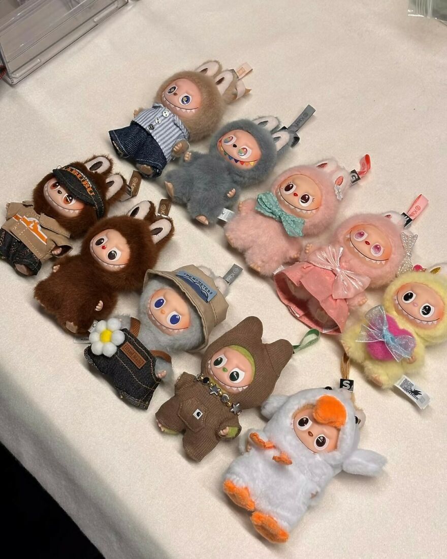 A collection of cute plush dolls in various costumes representing unforgettable 2025 pop culture moments.