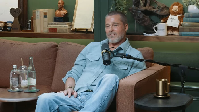 Man in casual clothes speaking into a microphone on a podcast set about people think celebrities closet skeletons.