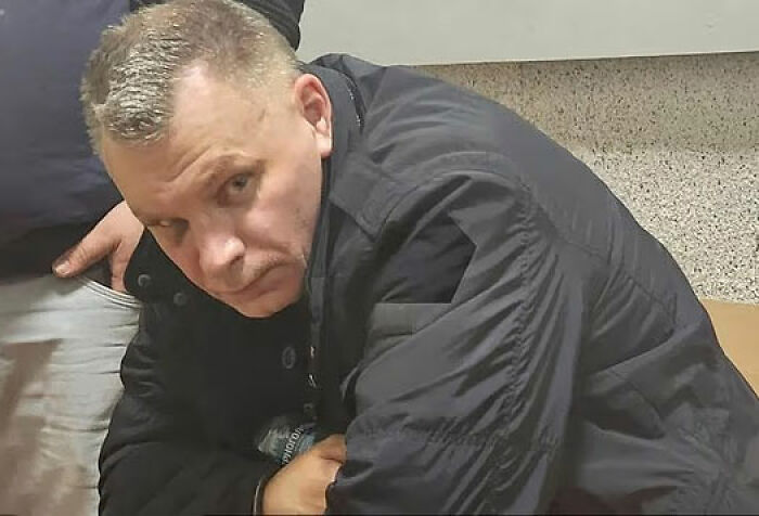 Man in black jacket looking serious indoors, related to crypto scammer case in Dubai mall investigation. Man in black jacket looking serious indoors, related to crypto scammer case in Dubai mall investigation.