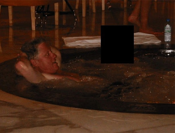 Man relaxing in a dark hot tub with a toddler's foot appearing near him, referencing chilling new files exposed.