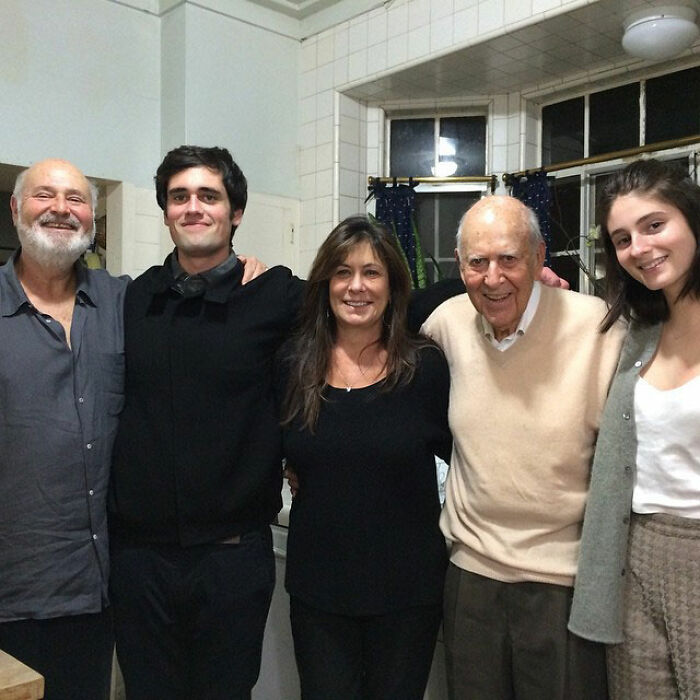 Family photo featuring Rob Reiner&rsquo;s daughter Romy and brother Nick with relatives in a cozy kitchen setting.