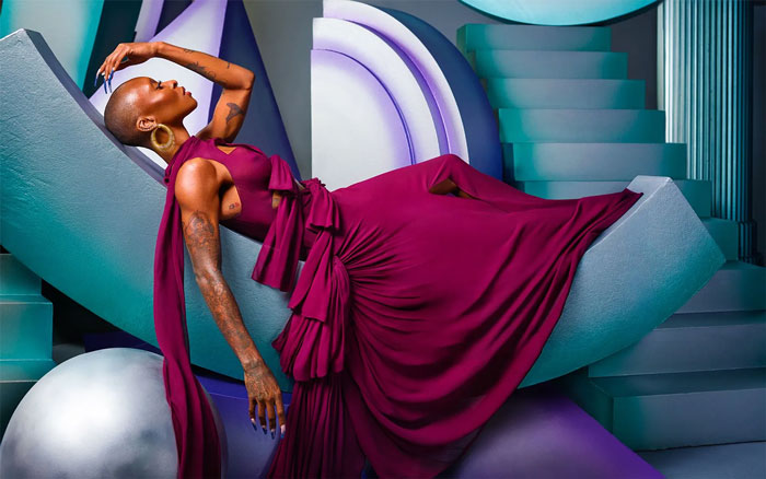 Cynthia Erivo poses in a flowing magenta gown on a modern abstract set, embodying style and confidence for magazine cover. Cynthia Erivo poses in a flowing magenta gown on a modern abstract set, embodying style and confidence for magazine cover.