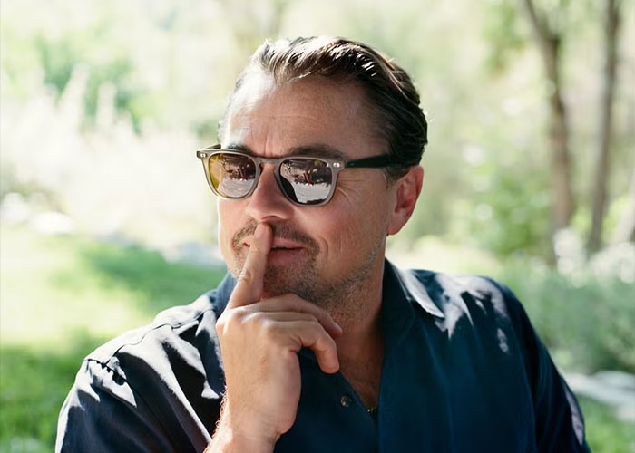 Leonardo DiCaprio wearing sunglasses outdoors, reflecting thoughtful expression linked to dating history speculation.