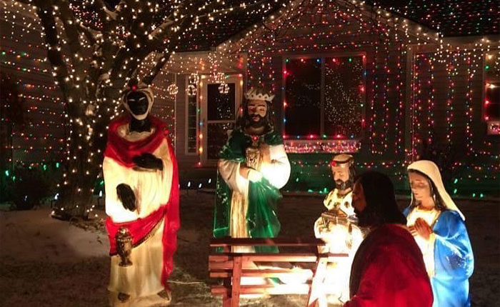 Outdoor nativity scene with colorful Christmas lights decorating a house, representing the viral Christmas lawyer story.