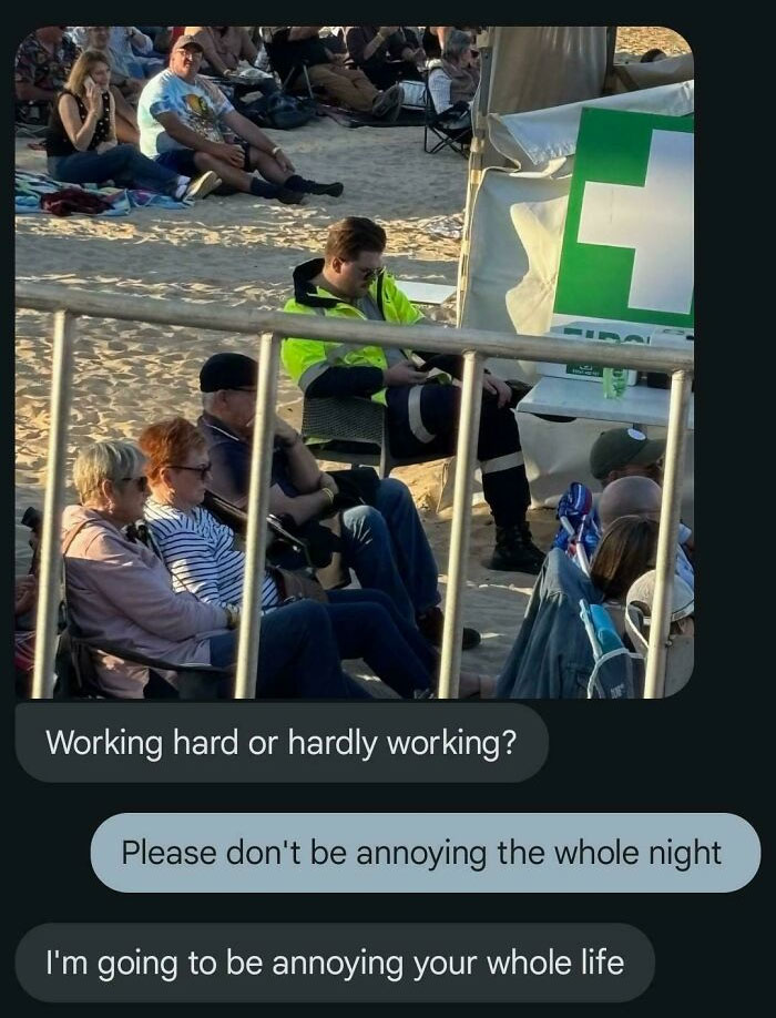 Man in high-visibility jacket texting at outdoor event, with humorous text messages about working hard or hardly working.