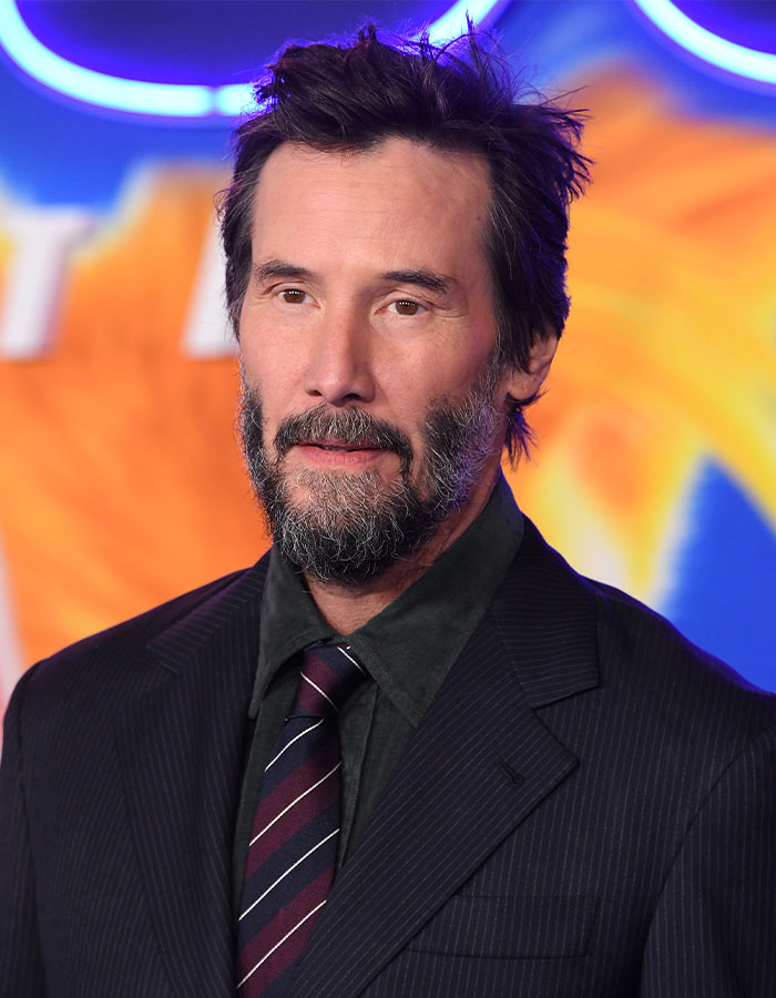 Actor with beard and suit at an event, representing outrageous demands actors have allegedly put in their contracts.