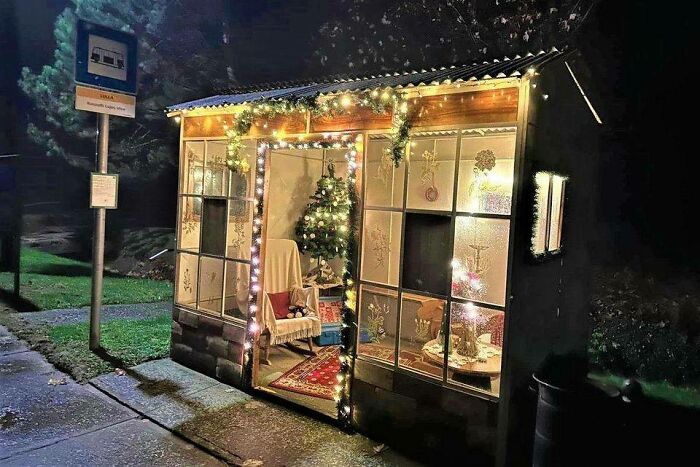 Bus stop decorated with Christmas lights and a festive tree, capturing an Eastern Europe nostalgic vibe in a cozy setting.