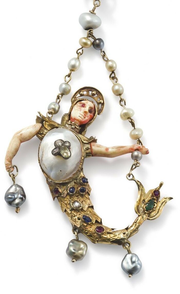 Vintage mermaid brooch with pearls and colorful gemstones, showcasing old craftsmanship and culture from the past.