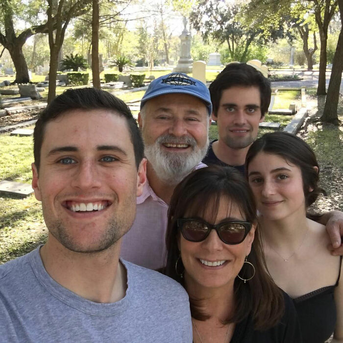 Rob Reiner&rsquo;s family posing outdoors with smiles, highlighting daughter Romy and brother Nick in a casual setting.