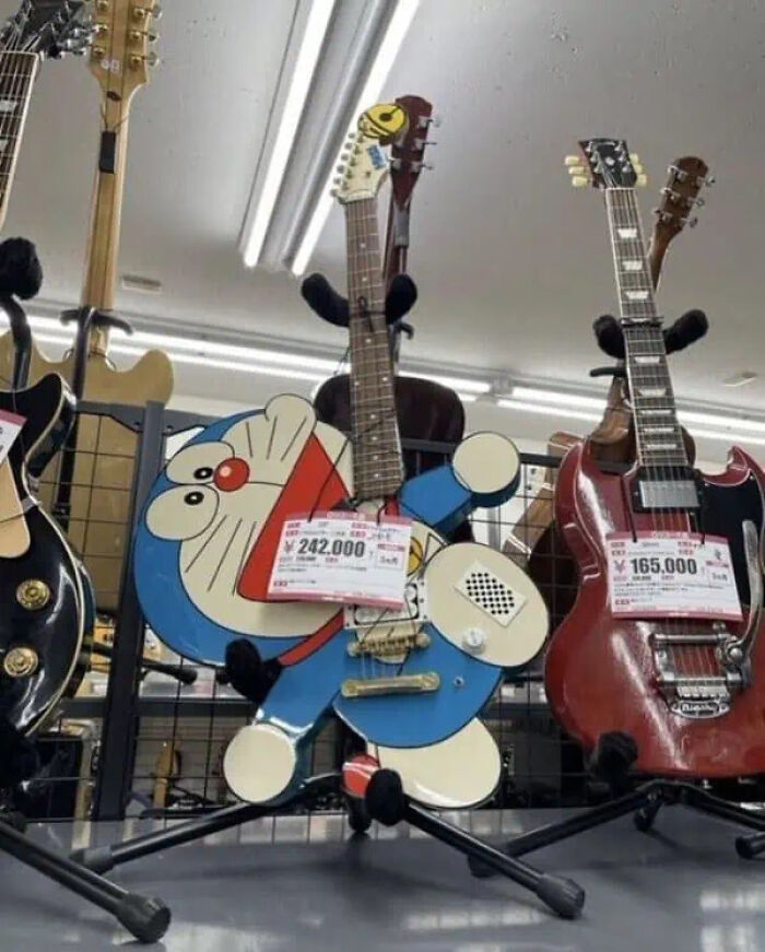 Electric guitar shaped like a cartoon character in a music store, showcasing trippy pictures that seem plucked from another reality.