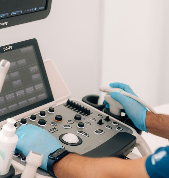 Close-up of a medical professional using ultrasound equipment during a patient exam, highlighting embarrassing moments in front of doctors.
