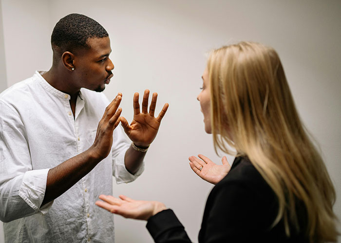 Man and woman having an intense conversation, illustrating people sharing the most insane things their ex ever did moments.