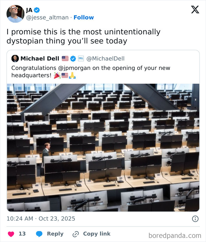 Man walking alone in a large office with rows of empty desks and computers, reflecting a sad uninspiring dystopia.