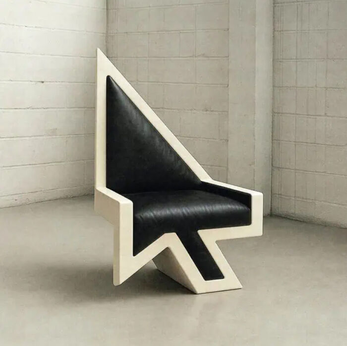 Arrow-shaped chair with black and white design in a minimalist room, showcasing trippy pictures style and surreal reality vibe.