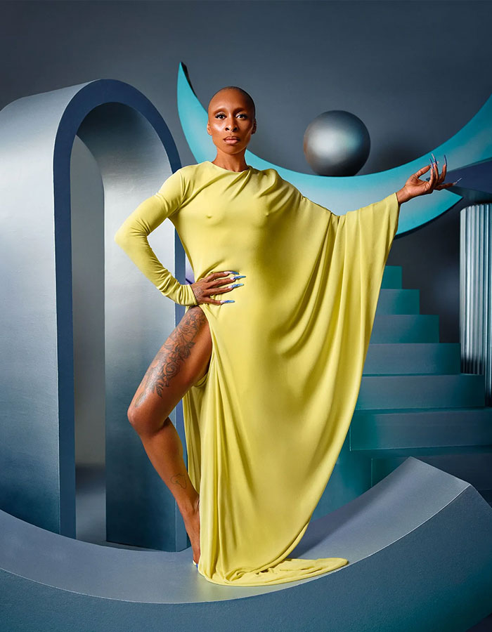 Cynthia Erivo in a flowing yellow gown, posing confidently on a futuristic set, embodying Ariana influence. Cynthia Erivo in a flowing yellow gown, posing confidently on a futuristic set, embodying Ariana influence.