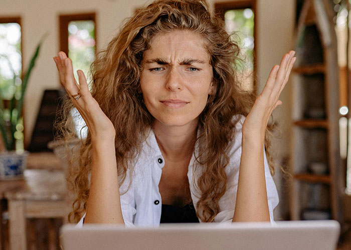 Confused woman with curly hair reacting to wild stories shared about the most insane thing their ex ever did.