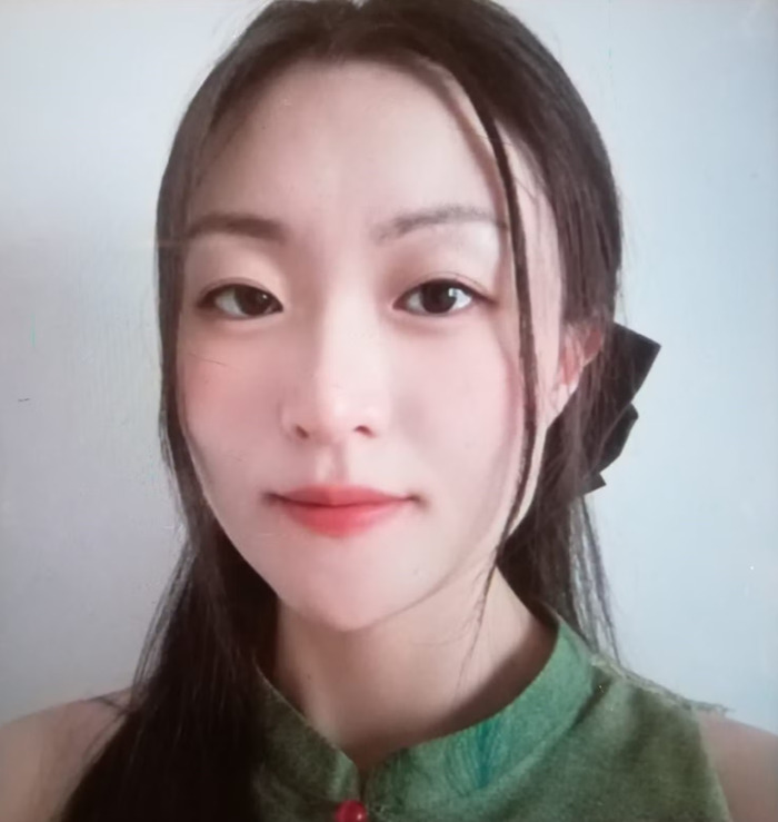 Young woman with long dark hair and a green top, representing the wealthy US student behavior story after altercation.