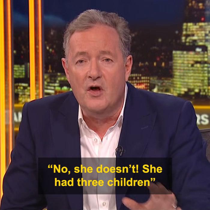 Man in a suit discussing Candace Owens&rsquo; comment about Brigitte Macron, with city lights visible in the background.