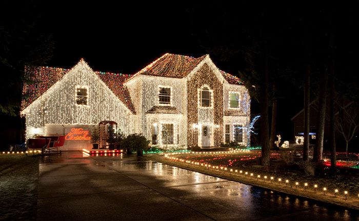 House covered in Christmas lights at night, showcasing a festive display after winning against the HOA.