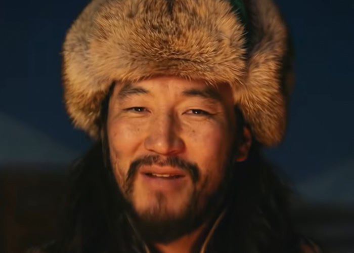 Mongolian throat singer wearing a traditional fur hat performing the viral Jingle Bells Christmas anthem of 2025.