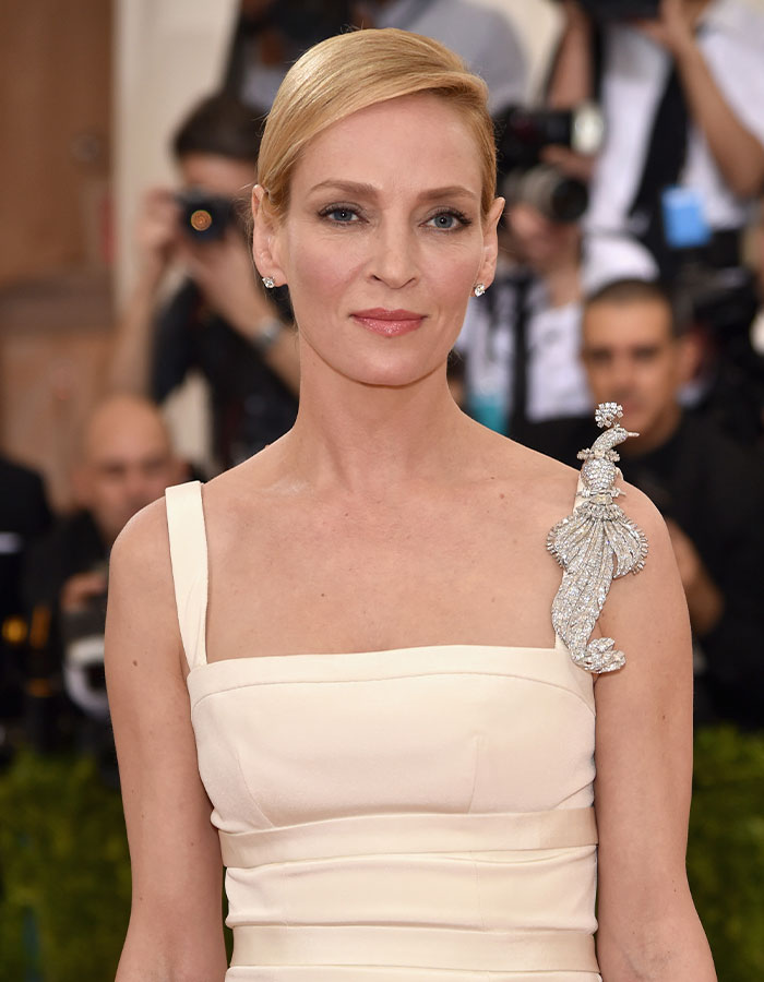 Actress wearing elegant off-white dress with jeweled shoulder detail at an event, illustrating outrageous actor contract demands.