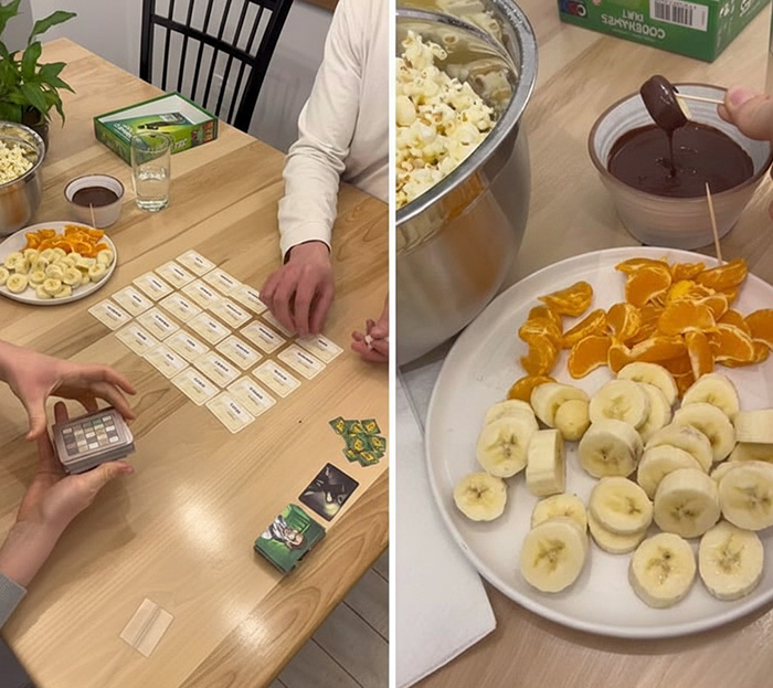 Couple enjoying at-home date night ideas playing a card game and dipping fruit in chocolate fondue.