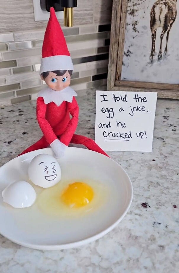 Elf on the Shelf prank with c*****d egg and funny note about telling the egg a joke on kitchen counter surface