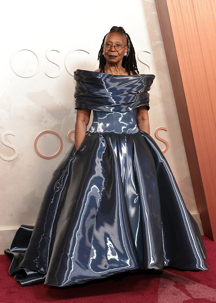 Celebrity fashion disaster from 2025 showing an unusual shiny off-shoulder ball gown on the red carpet.