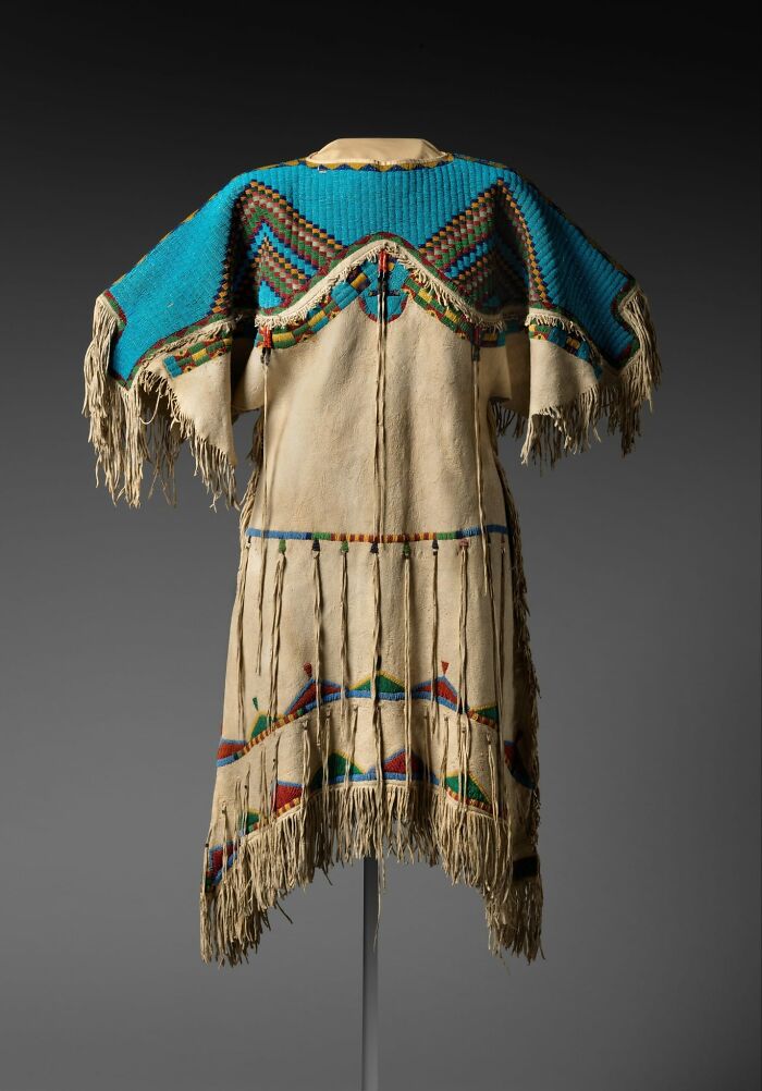Traditional Native American garment with intricate beadwork and fringe, capturing culture and emotion from the past.