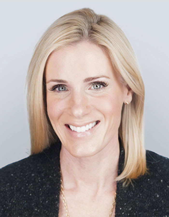 HR Exec Kristin Cabot smiling with blonde hair, wearing a black top, posing for a professional headshot portrait