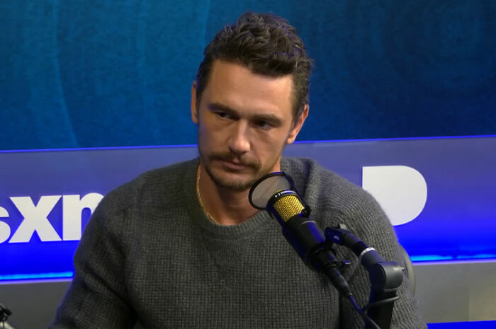 James Franco speaking into a microphone during a podcast interview, sharing insights about being cast out of Hollywood. James Franco speaking into a microphone during a podcast interview, sharing insights about being cast out of Hollywood.