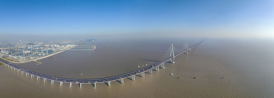Aerial view of remarkable engineering on one of the 12 longest bridges in the world spanning a wide river.