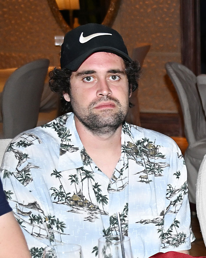 Man wearing black Nike cap and palm tree print shirt, reportedly linked to Nick Reiner startling diagnosis and erratic behavior.