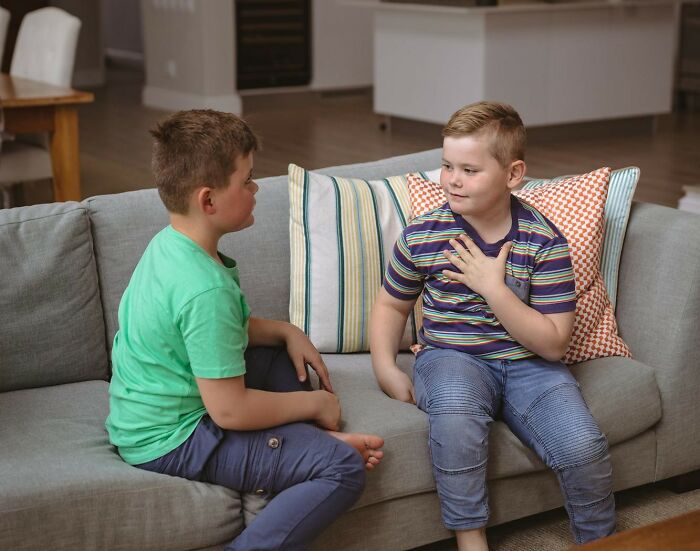 Two boys sitting on a couch having a conversation, illustrating a kid's insult that is strange and specific.