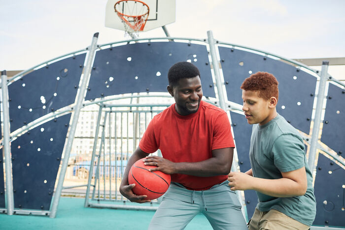 Two men playing basketball outdoors, illustrating moments from revenge stories that left a bitter aftertaste.