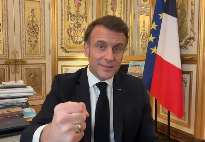 French soldier&rsquo;s odd behavior behind Macron in ornate room with French flag sparks France is boiling conspiracy theories.