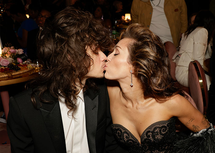 Miley Cyrus and Maxx Morando share a kiss at an event, sparking mixed reactions about their engagement and age difference.