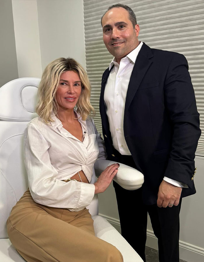 Brandi Glanville with a doctor in a clinical setting after receiving diagnosis for facial disfigurement condition.