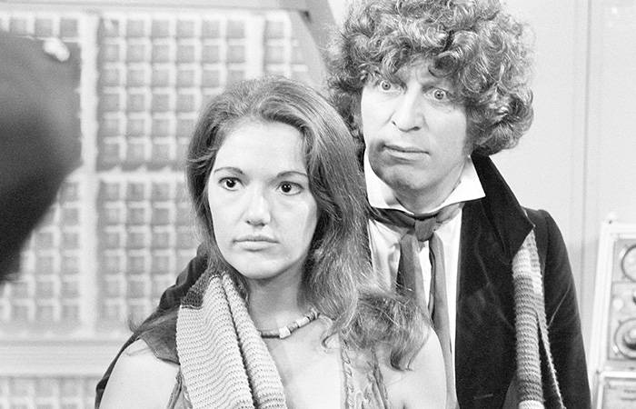 Black and white image of two actors in vintage costumes from one of the longest running TV shows of all time.