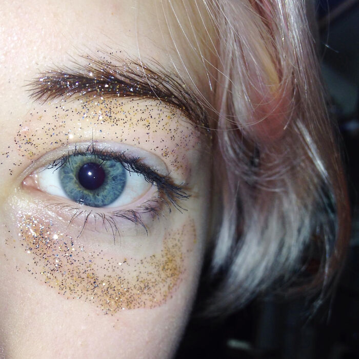 Close-up of a person's eye with glitter on the skin, illustrating emotions in revenge stories with a bitter aftertaste.